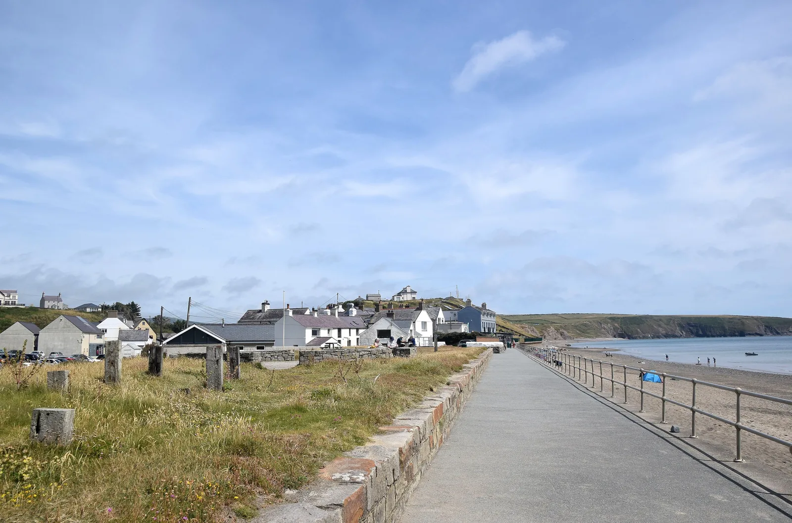 The promenade at Aberdaron running along the shore below the churchyard wall, the bay opening out to the right