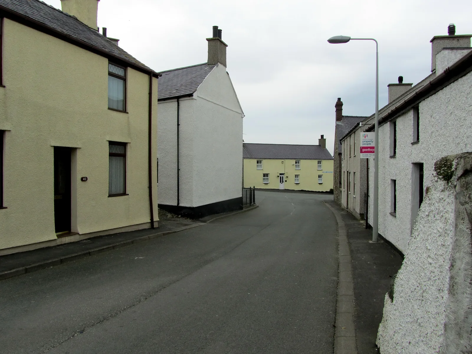 Church Street at Aberffraw, rendered houses close on both sides of the narrow road