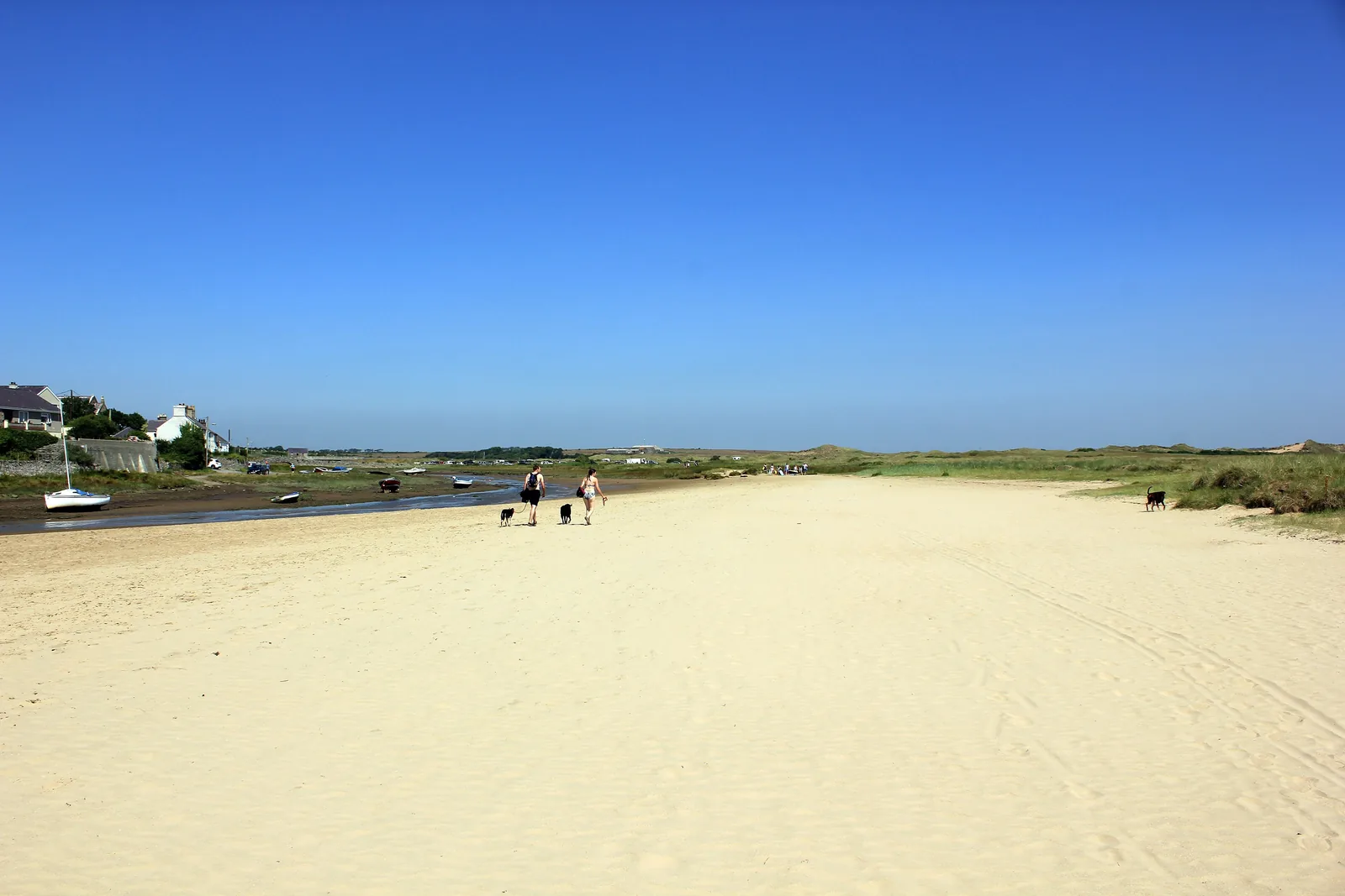The Anglesey Coastal Path at Aberffraw running between the beach and the dune grass, the estuary opening out beyond