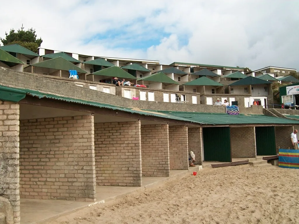 Tiered rows of painted beach huts above the sand at Porth Fawr, Abersoch