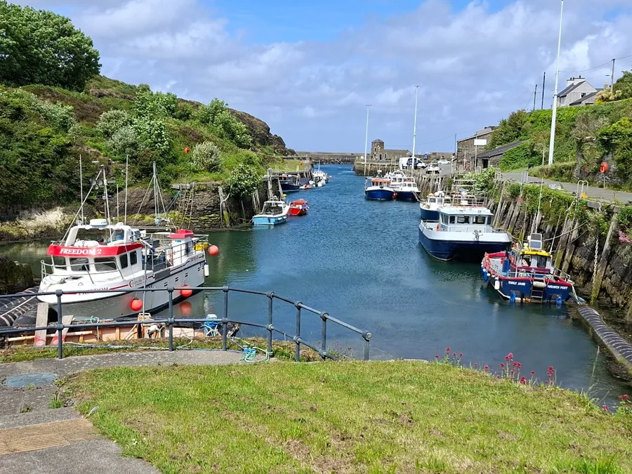 Fishing boats moored along the inlet at Porth Amlwch, the working harbour below Amlwch, Anglesey.