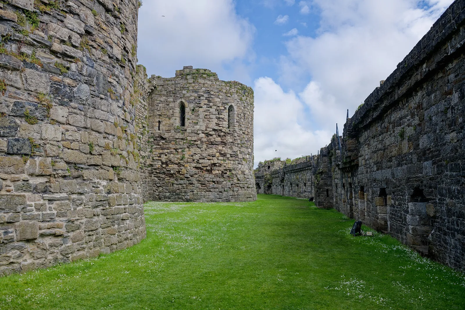 The Chapel Tower of Beaumaris Castle seen from the west, its weathered stone walls rising above the moat.