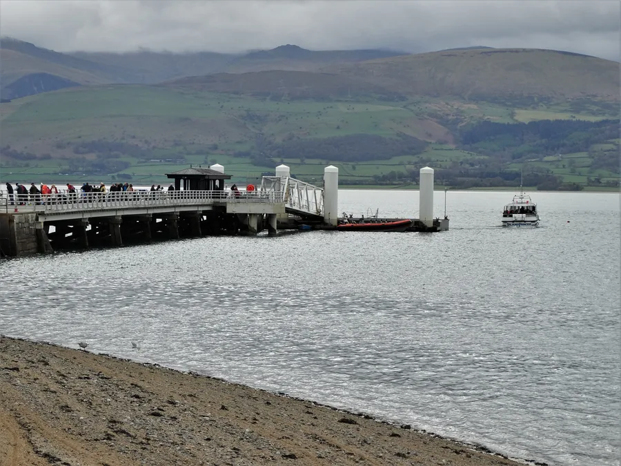 Beaumaris Pier reaching into the Menai Strait, the mountains of Eryri beyond.