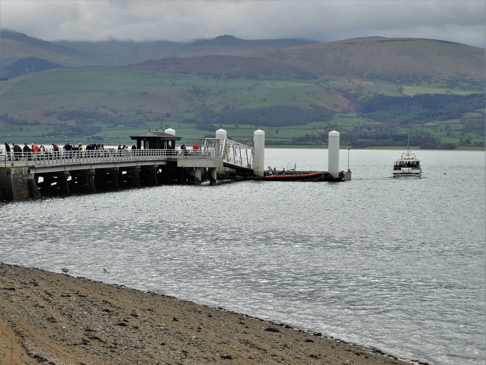 Beaumaris Pier reaching into the Menai Strait, the mountains of Eryri beyond.