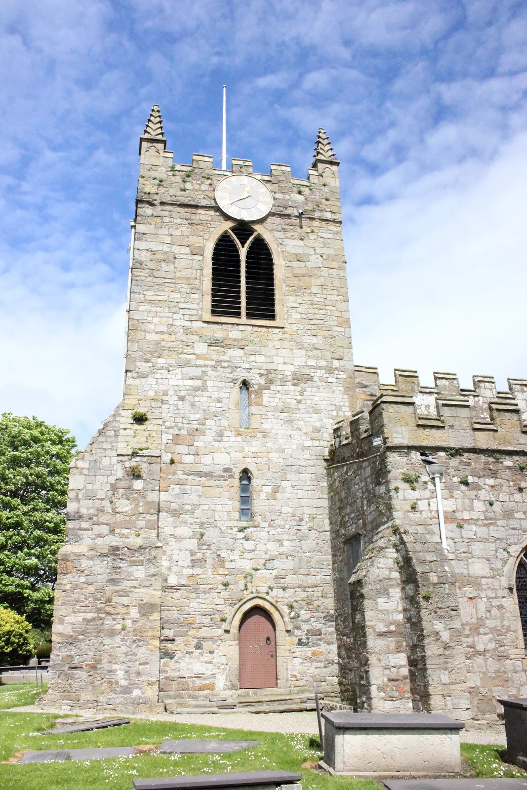 The 14th-century tower of St Mary and St Nicholas Church, Beaumaris, seen from the churchyard