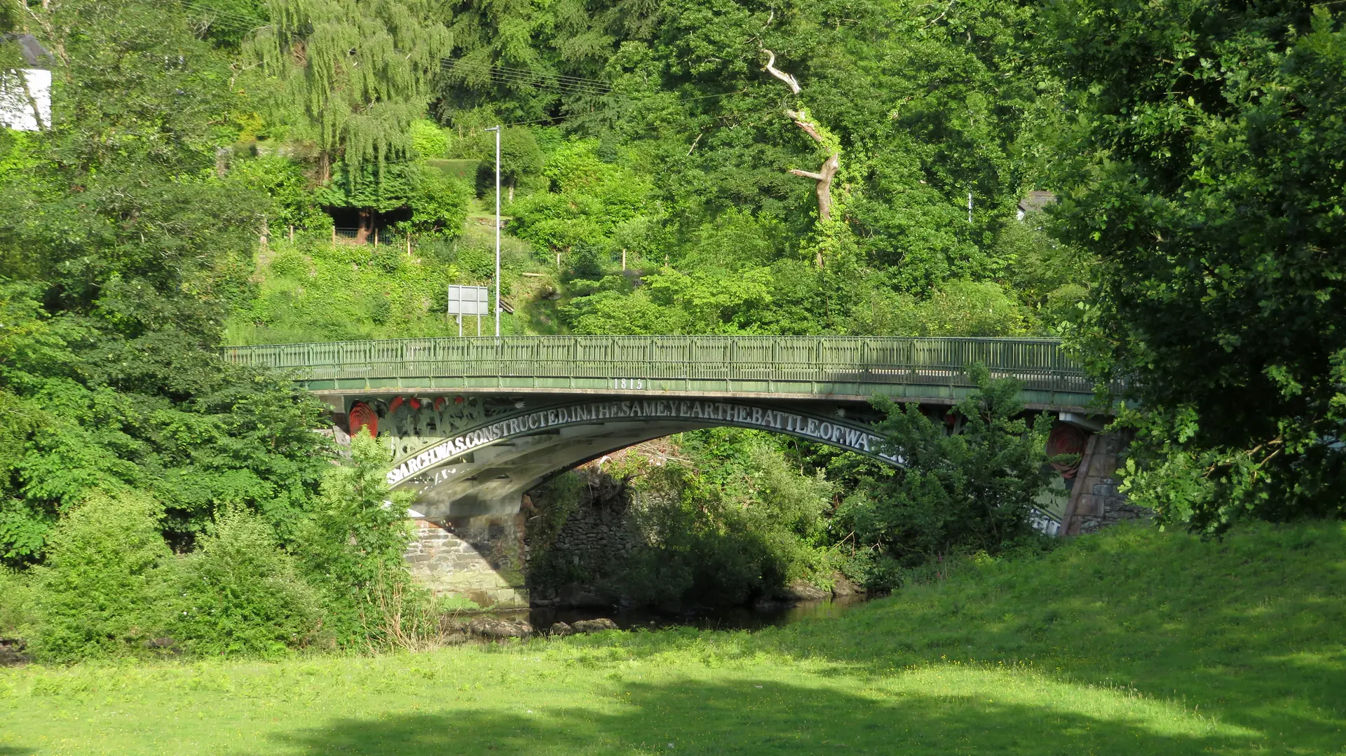 Telford&rsquo;s Waterloo Bridge carrying the A5 over the River Conwy at Betws-y-Coed, wooded hillsides rising behind