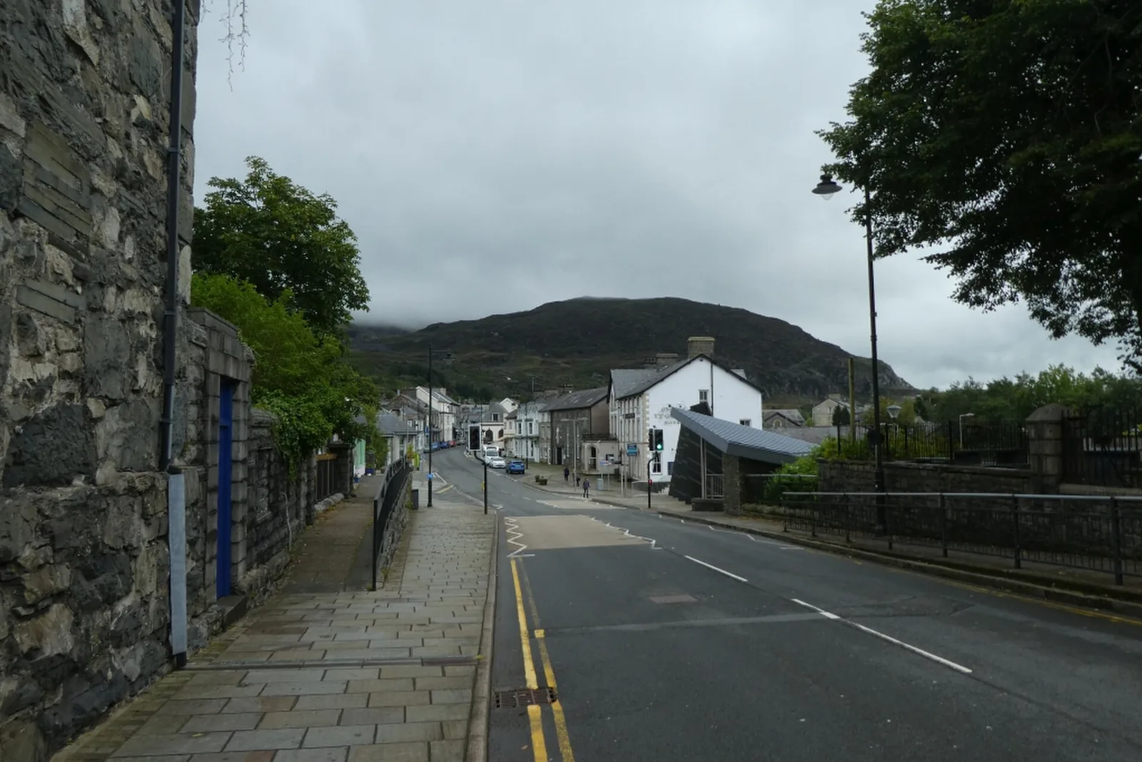 Church Street, Blaenau Ffestiniog, shopfronts and a stone building beneath the hillside