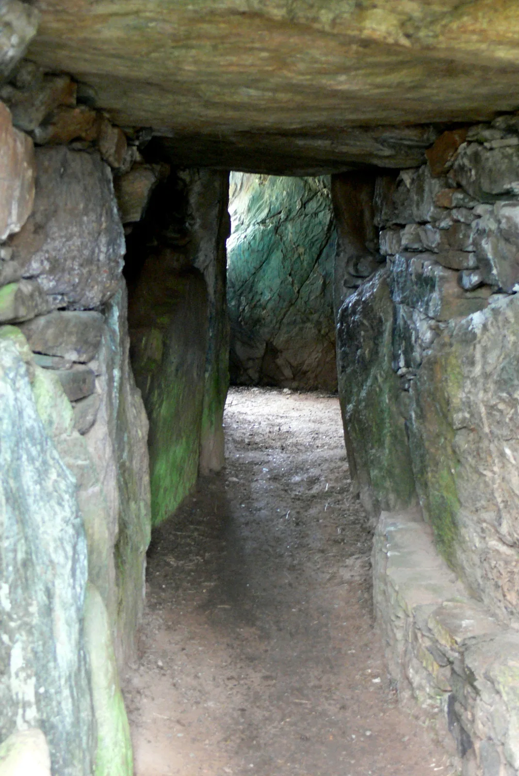 The low, stone-lined passage leading into the burial chamber of Bryn Celli Ddu.