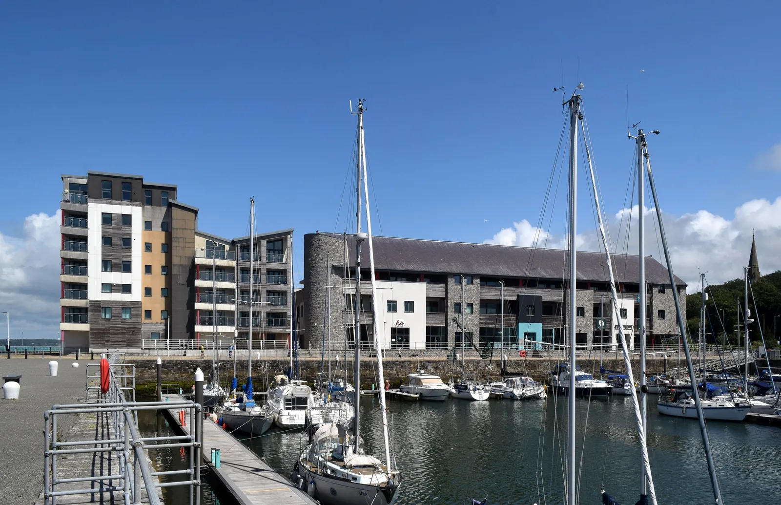 Yachts in the marina at Doc Fictoria, Caernarfon, the Galeri building and waterside apartments behind