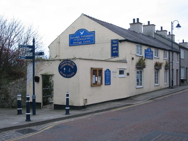 Cemaes Heritage Centre on High Street, a whitewashed corner building with blue signage
