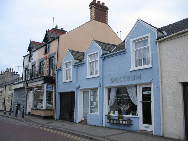 A row of painted shopfronts and houses on High Street, Cemaes