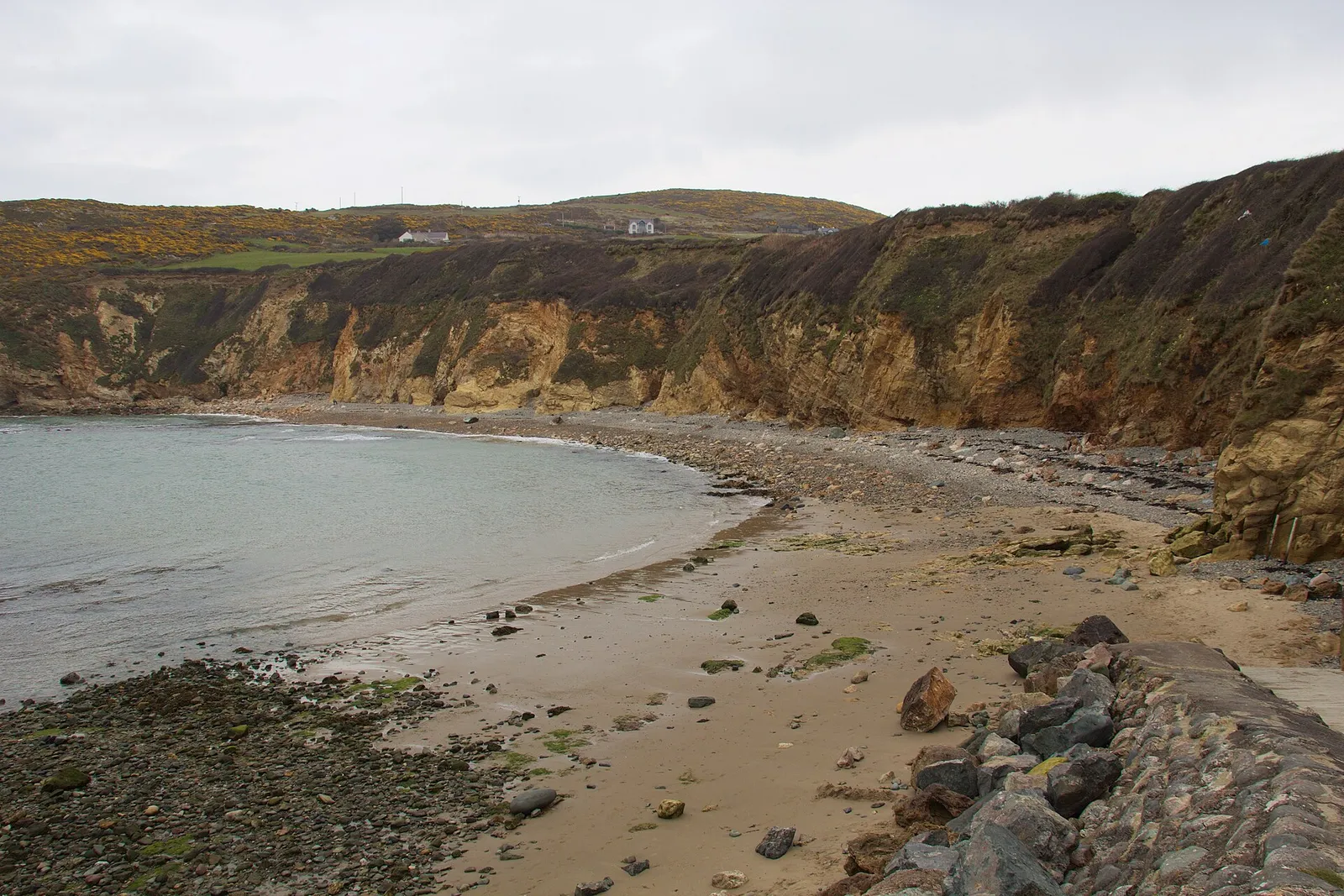 Church Bay cove from above: cliffs, cottages and the beach below