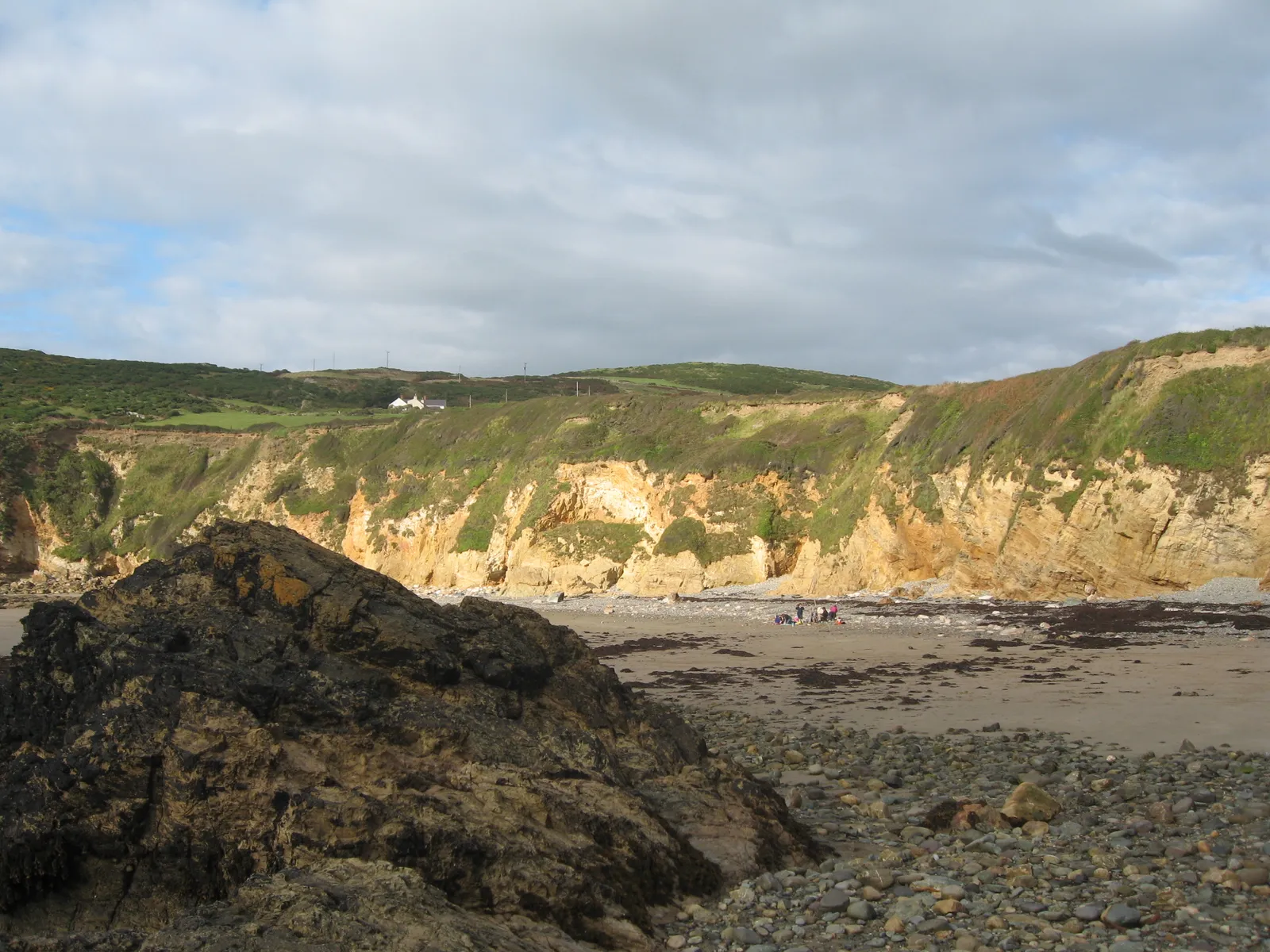 Church Bay beach, Anglesey, showing an orange rock exposure at low water