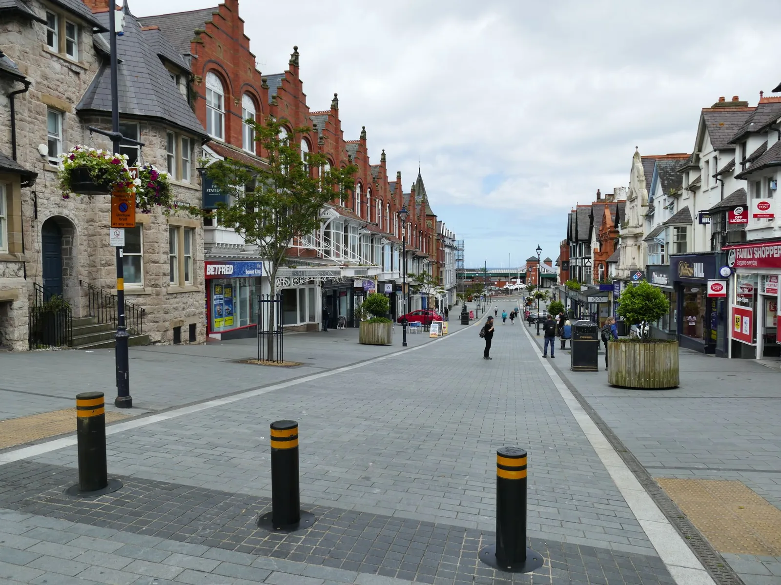 Station Road, Colwyn Bay, a pedestrianised shopping street with planters and Victorian frontages