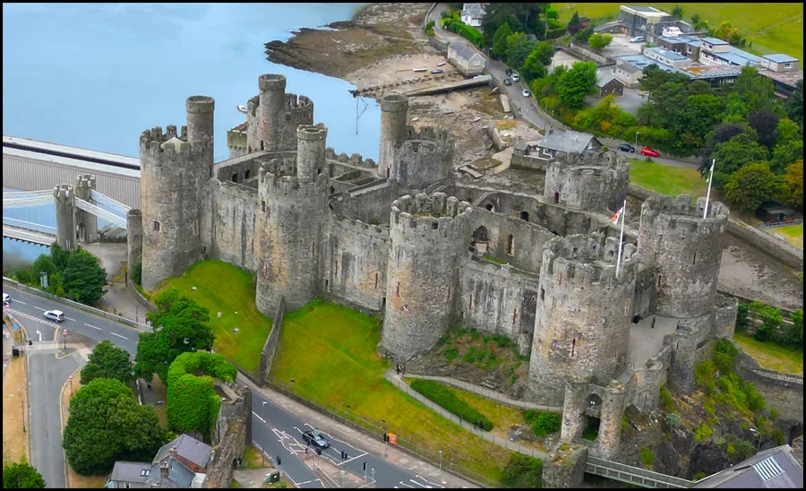 The eight round towers and curtain walls of Conwy Castle above the town and estuary, Conwy.