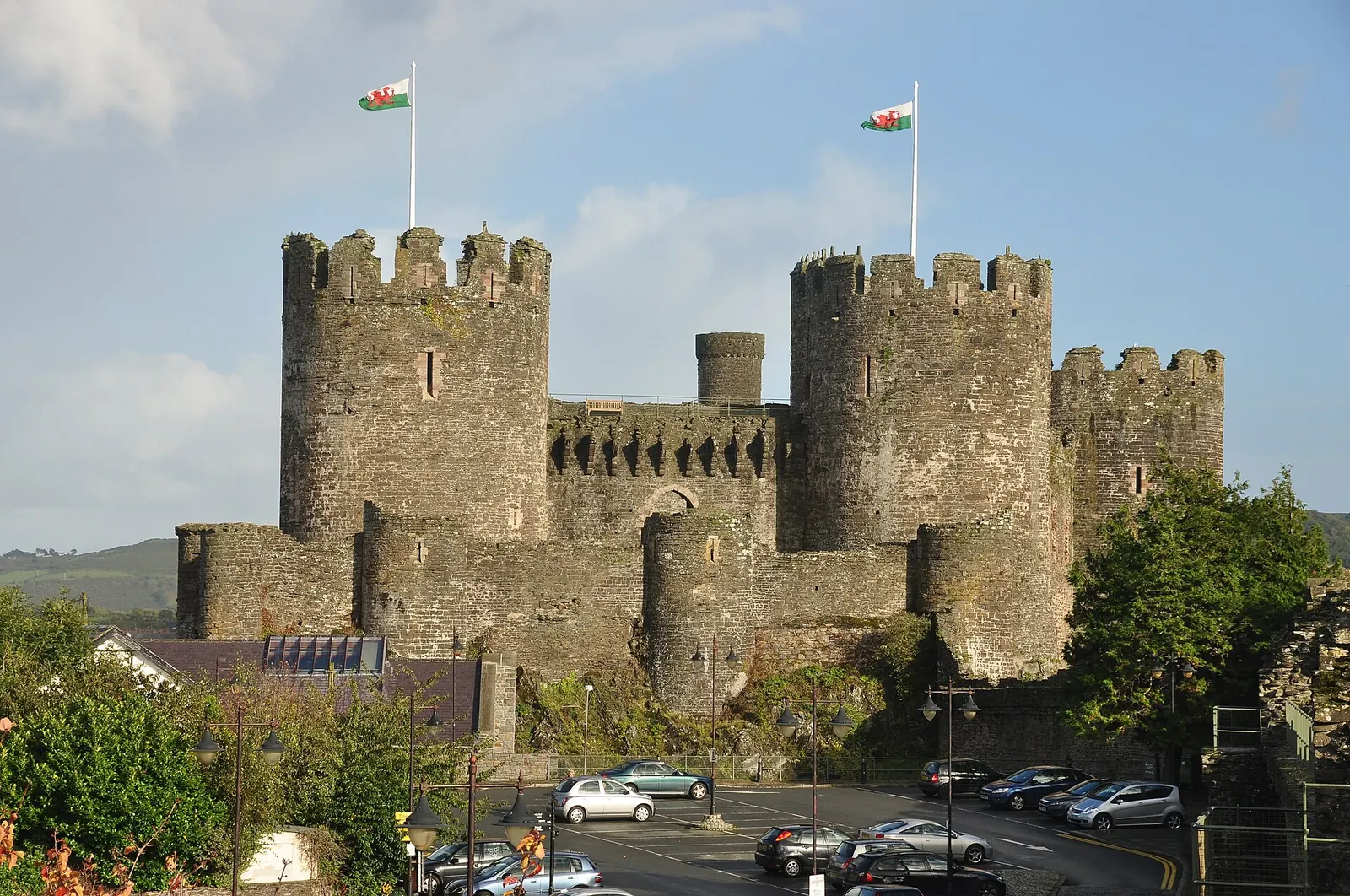 Conwy Castle's row of round towers with crenellations, seen from outside on a clear day.