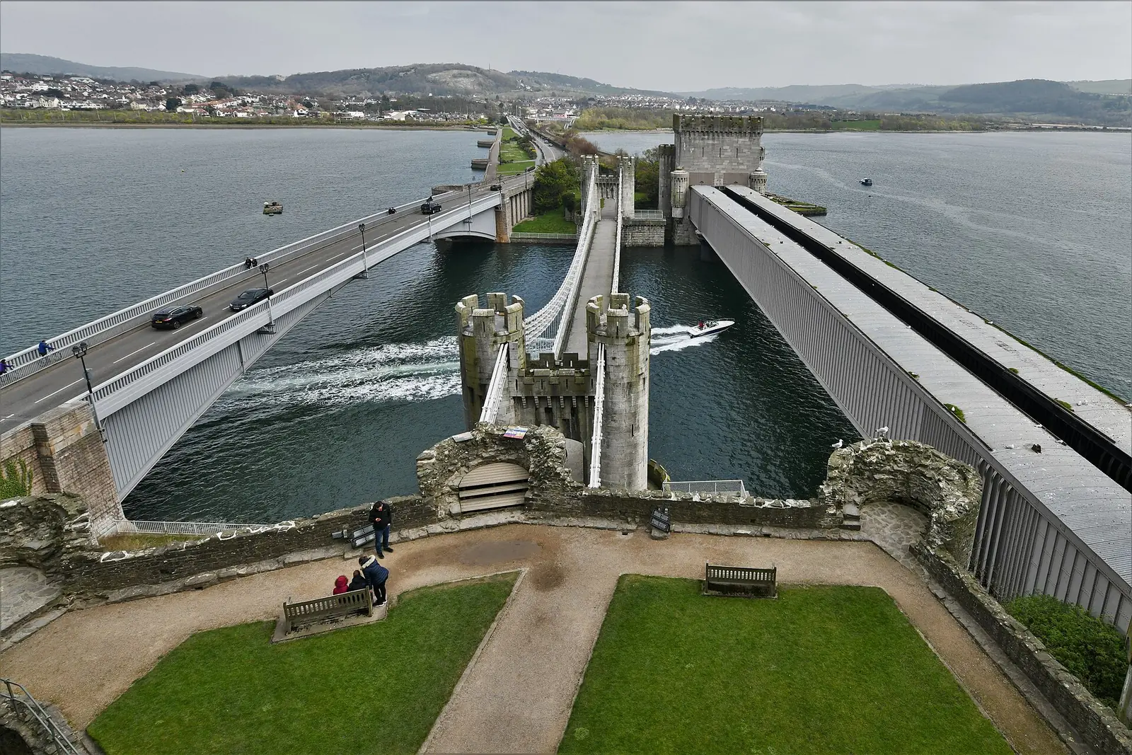 The road bridge and Telford's suspension bridge crossing the River Conwy, seen from the castle grounds.