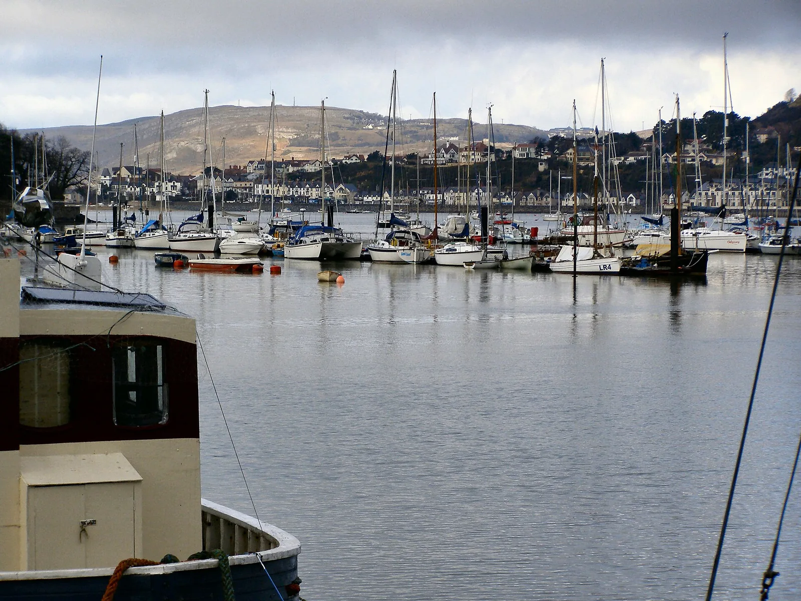 Boats on Conwy Harbour, the quay and town beyond