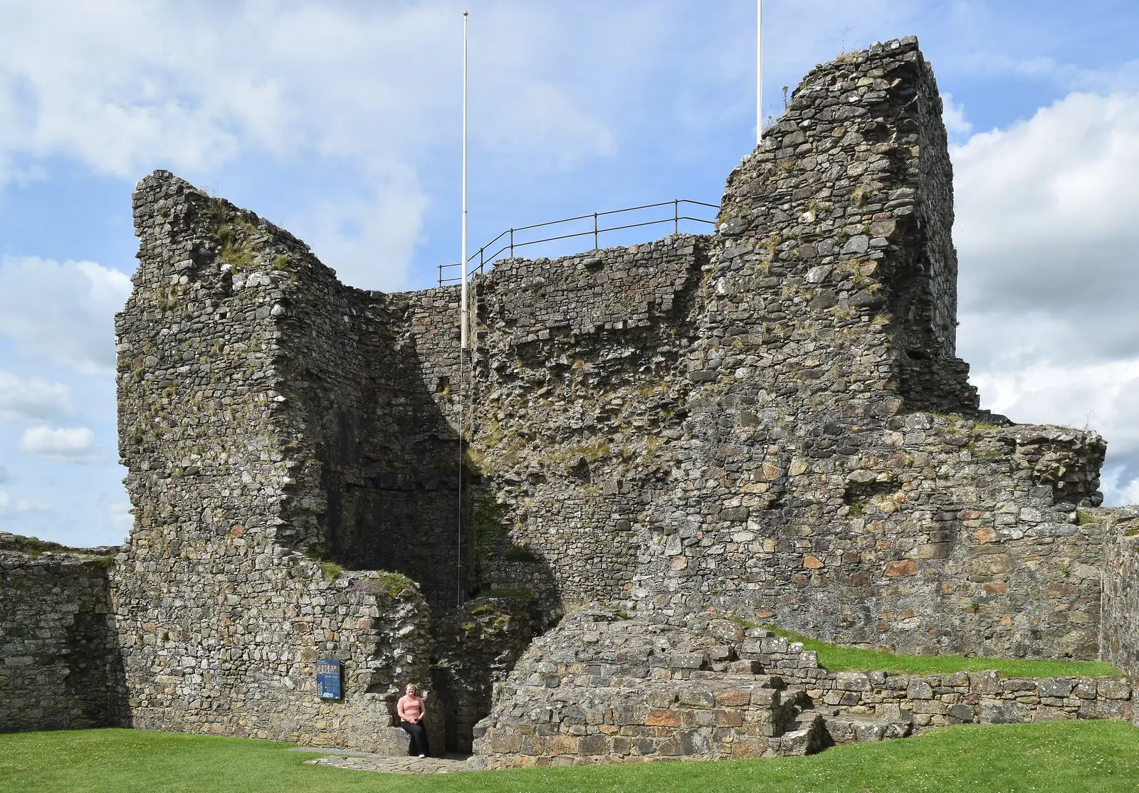 Looking upward at the stone walls and gateway of Criccieth Castle