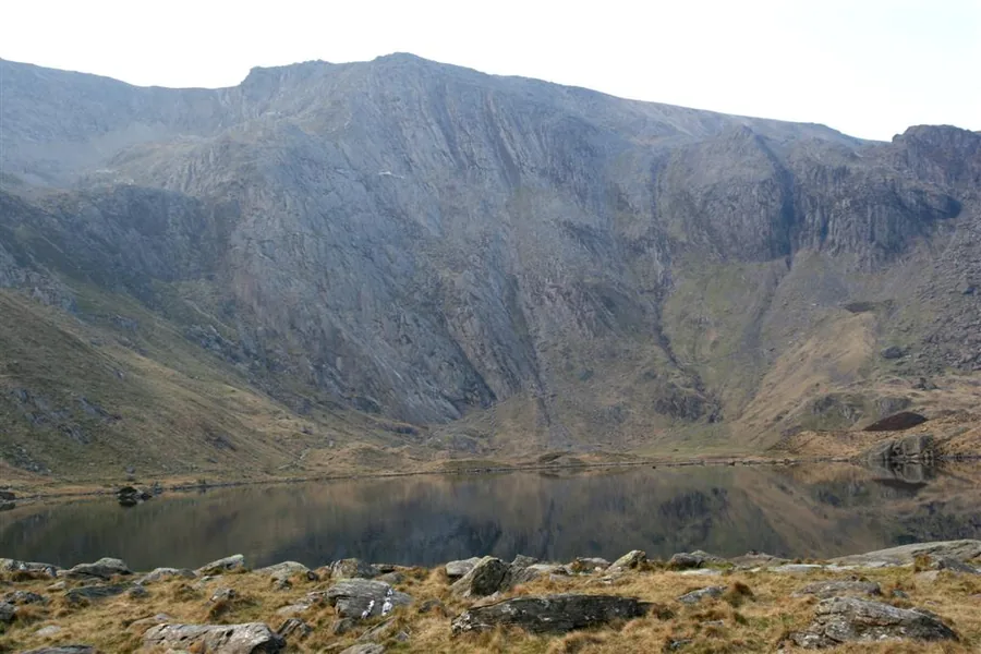 The dark water of Llyn Idwal below the rock headwall of Cwm Idwal, Ogwen valley, Gwynedd.