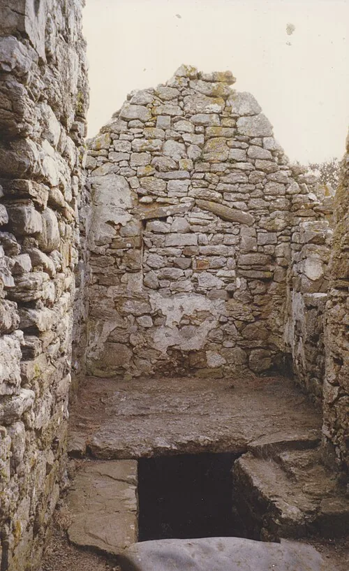The stone-walled vaulted crypt beneath the 16th-century side chapel at Capel Lligwy.