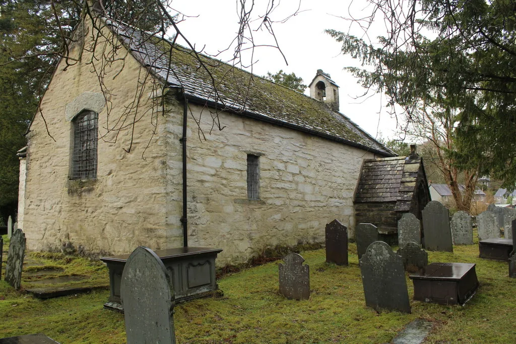 St Gwyddelan's Church at Dolwyddelan, a low whitewashed building with a slate roof and a stone bellcote