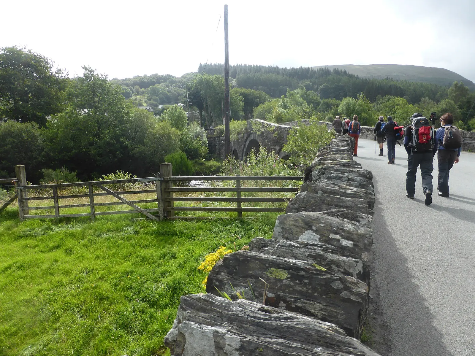 Pont-y-Llan seen along Bridge Street at Dolwyddelan, its stone parapet running towards the arches over the Lledr