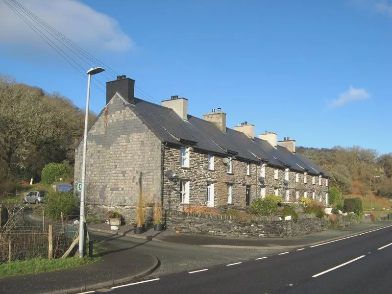 Prince Llewellyn Terrace at Dolwyddelan, a long row of stone quarry cottages standing directly on the roadside