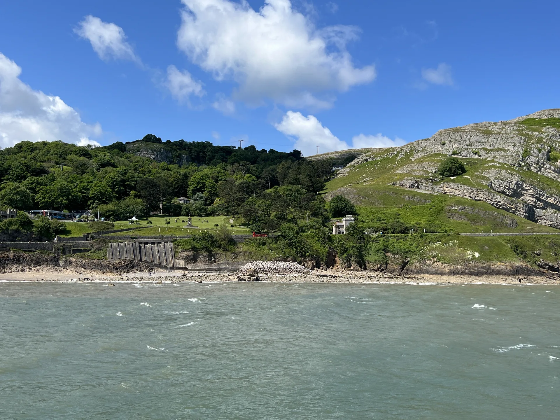 The limestone mass of the Great Orme rising above Llandudno and the sea, its grassy headland dropping to the town below.