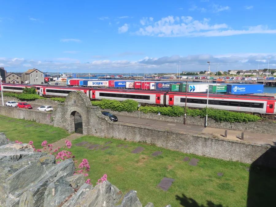 Holyhead&rsquo;s harbour and town below St Cybi&rsquo;s Church, with a train and the ferry port beyond, Holy Island, Anglesey.