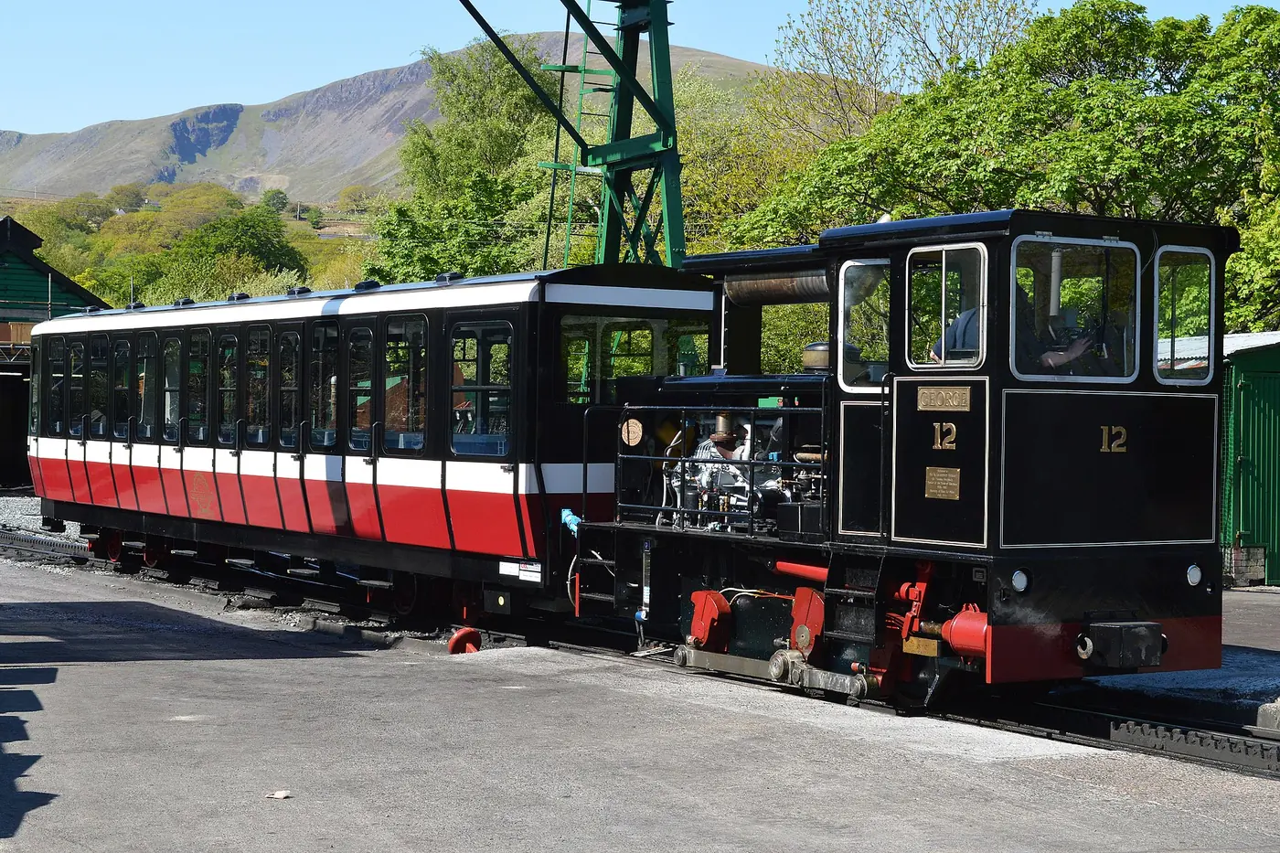A Snowdon Mountain Railway locomotive at Llanberis station, with the mountain behind