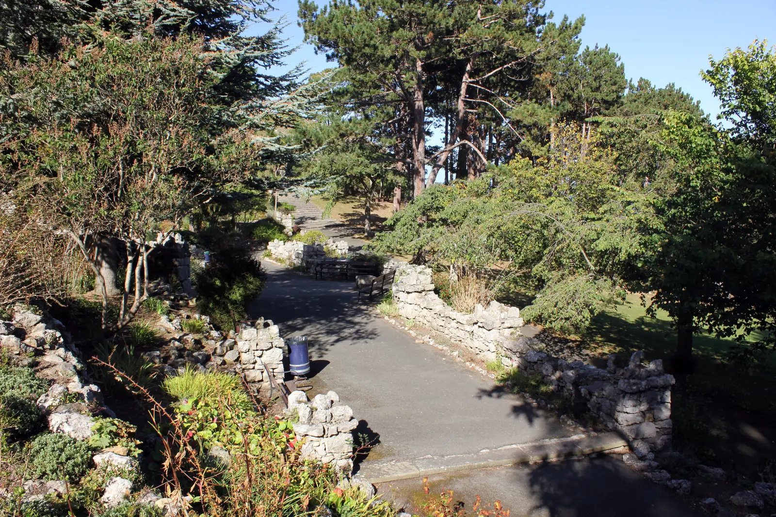Rock-garden paths and limestone outcrops among trees at Happy Valley, Llandudno
