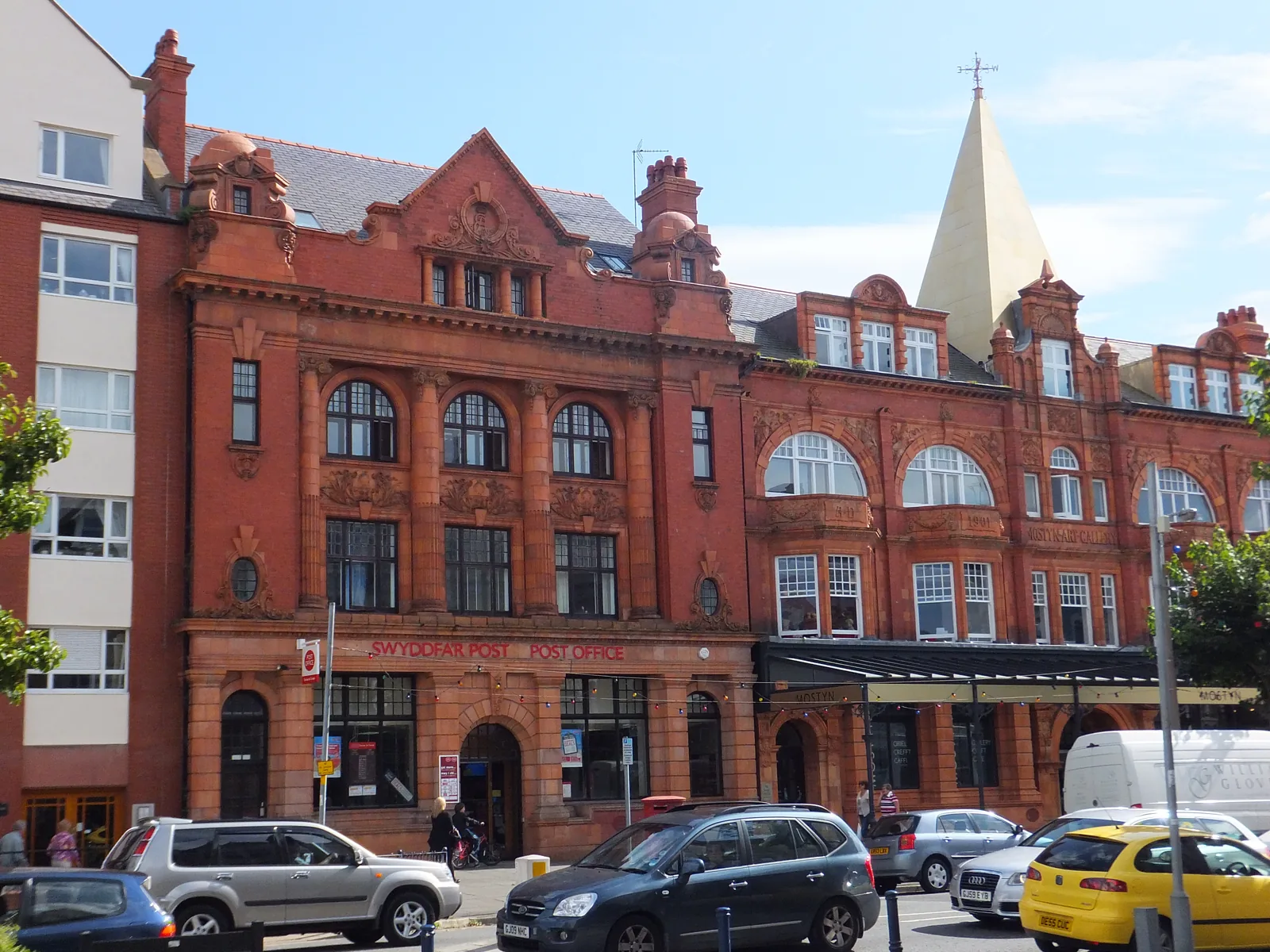 The red-brick and terracotta range on Vaughan Street, Llandudno, holding the head post office and the gallery