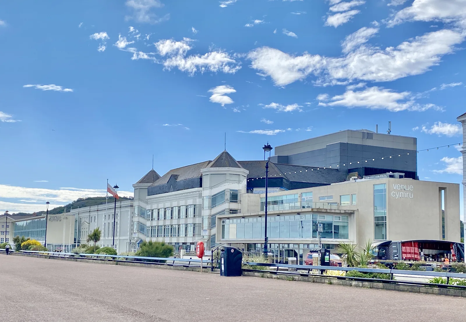 Venue Cymru seen from the promenade at Llandudno, its grey theatre block beside the seafront hotels