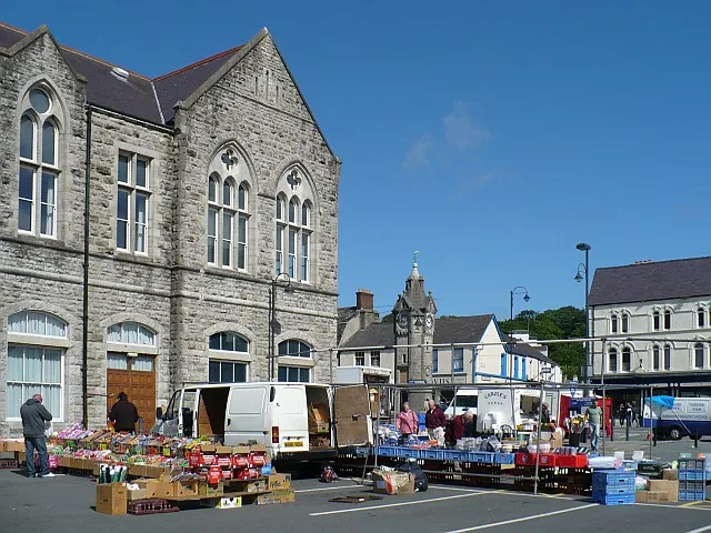 Market stalls set out in the Town Hall car park at Llangefni, the town hall on the left and the clock tower behind