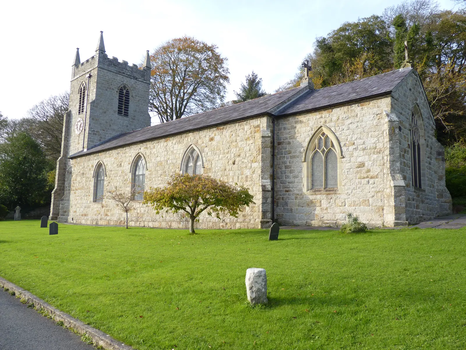St Cyngar's Church, Llangefni, its battlemented tower and long nave seen across the churchyard grass