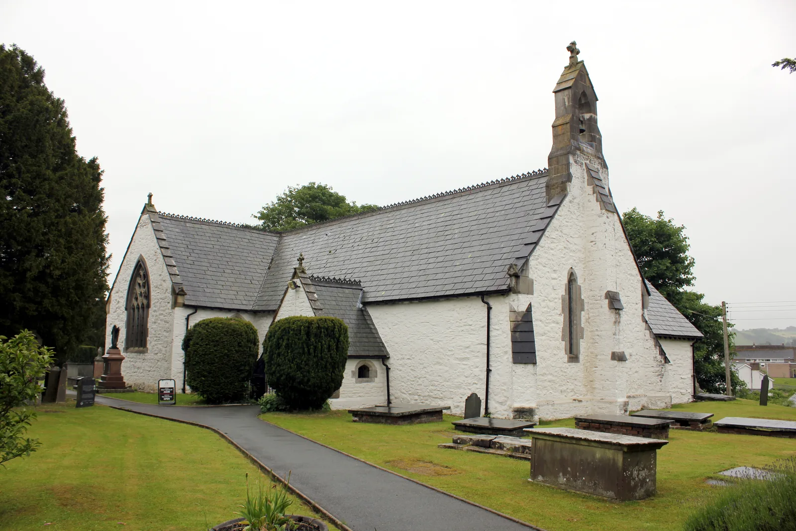 St Digain's Parish Church, Llangernyw, seen along the churchyard path between clipped yews