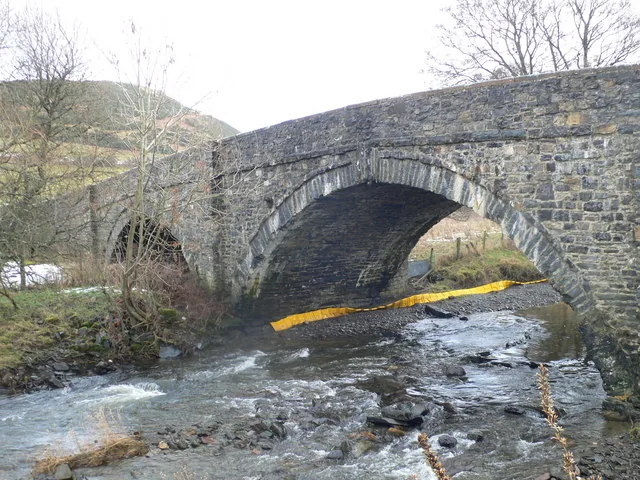 Pont Faen, a triple-arched stone bridge over the river on the eastern approach to Llangernyw