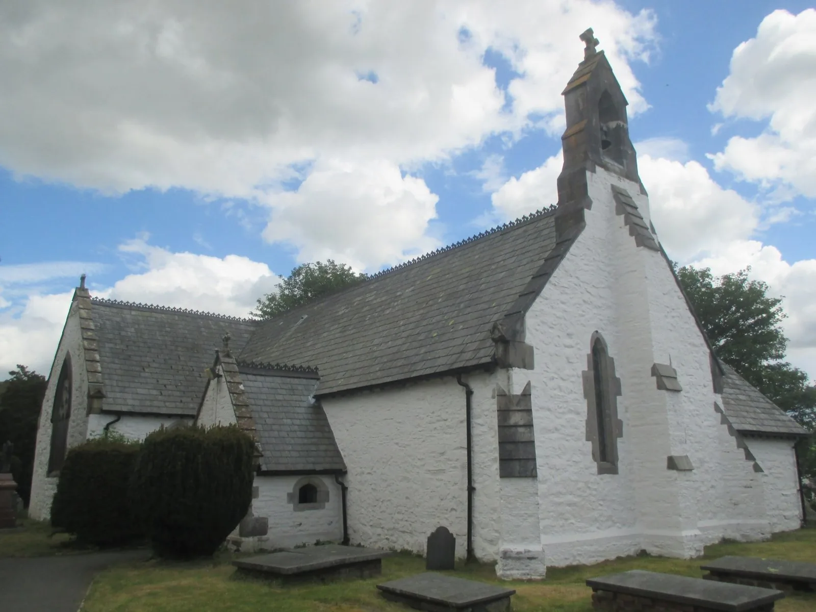 St Digain's Church at Llangernyw, whitewashed and low, under a moving sky