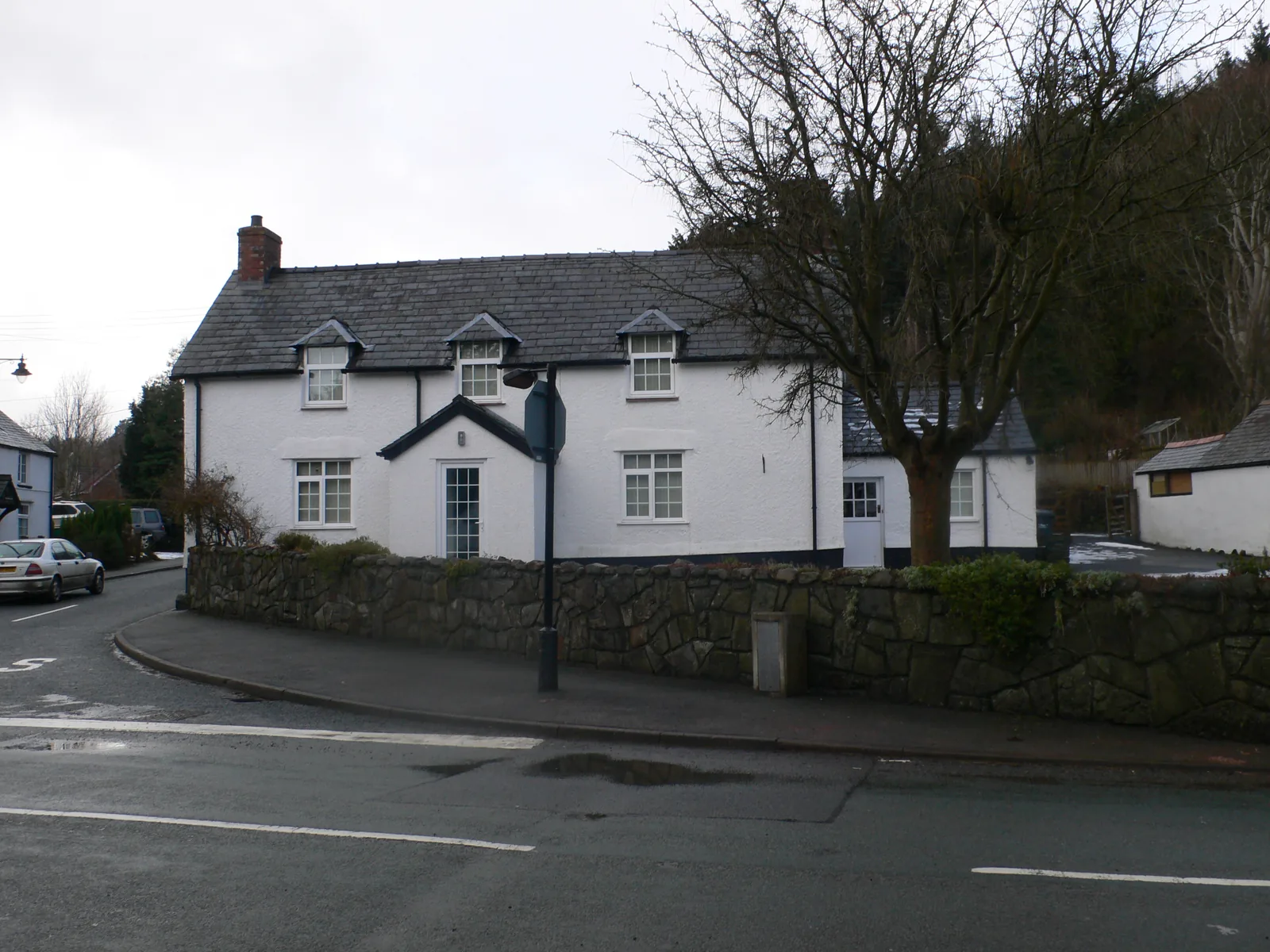 Ty'r Gof, a white house standing at the road junction in Llangernyw