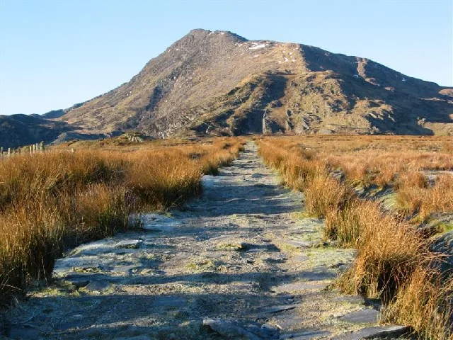 The stone path from Capel Curig running through moor grass toward Moel Siabod's ridge