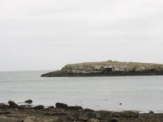 Ynys Moelfre seen across the tidal channel from the mainland headland north of Moelfre