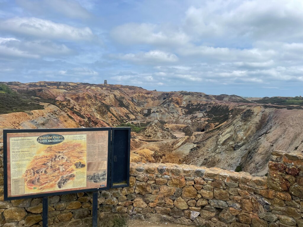 The rust, ochre and purple mineral slopes of Parys Mountain seen from the viewing platform above Amlwch on Anglesey.