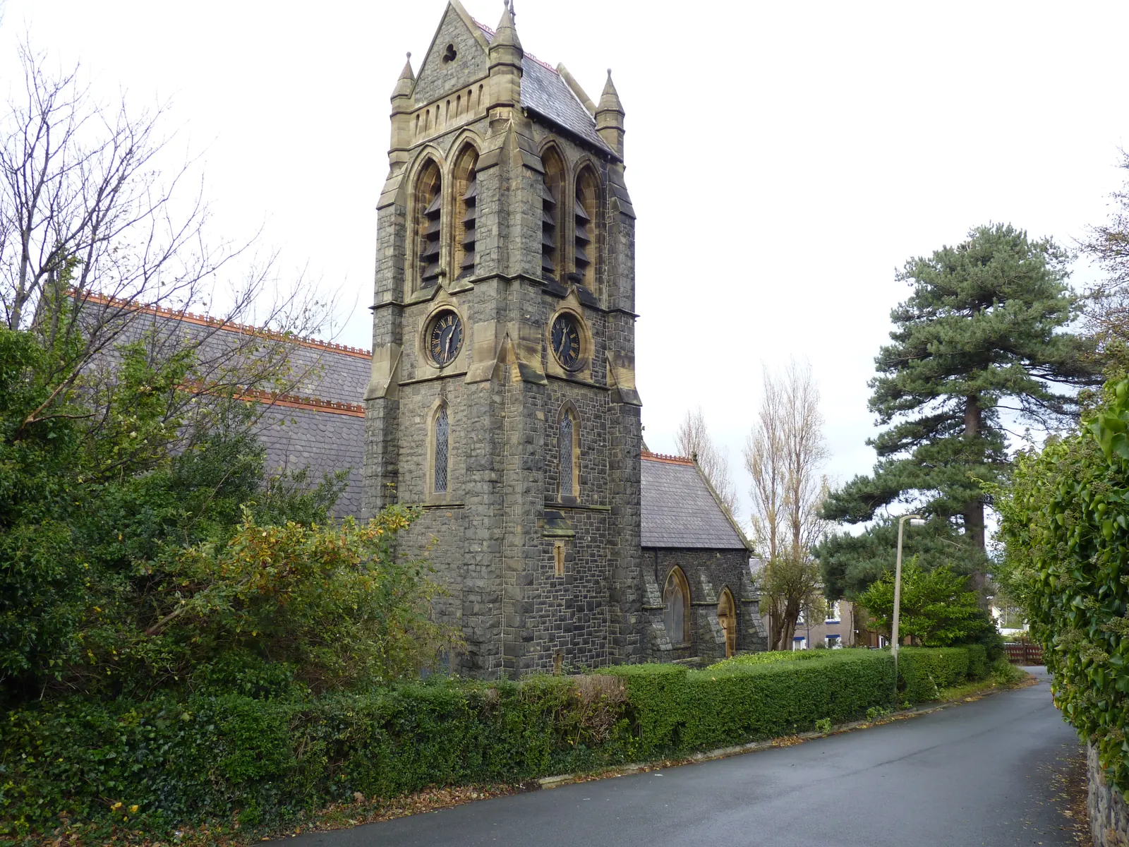 St Seiriol's Church, Penmaenmawr, its granite tower and slate roof rising above the road