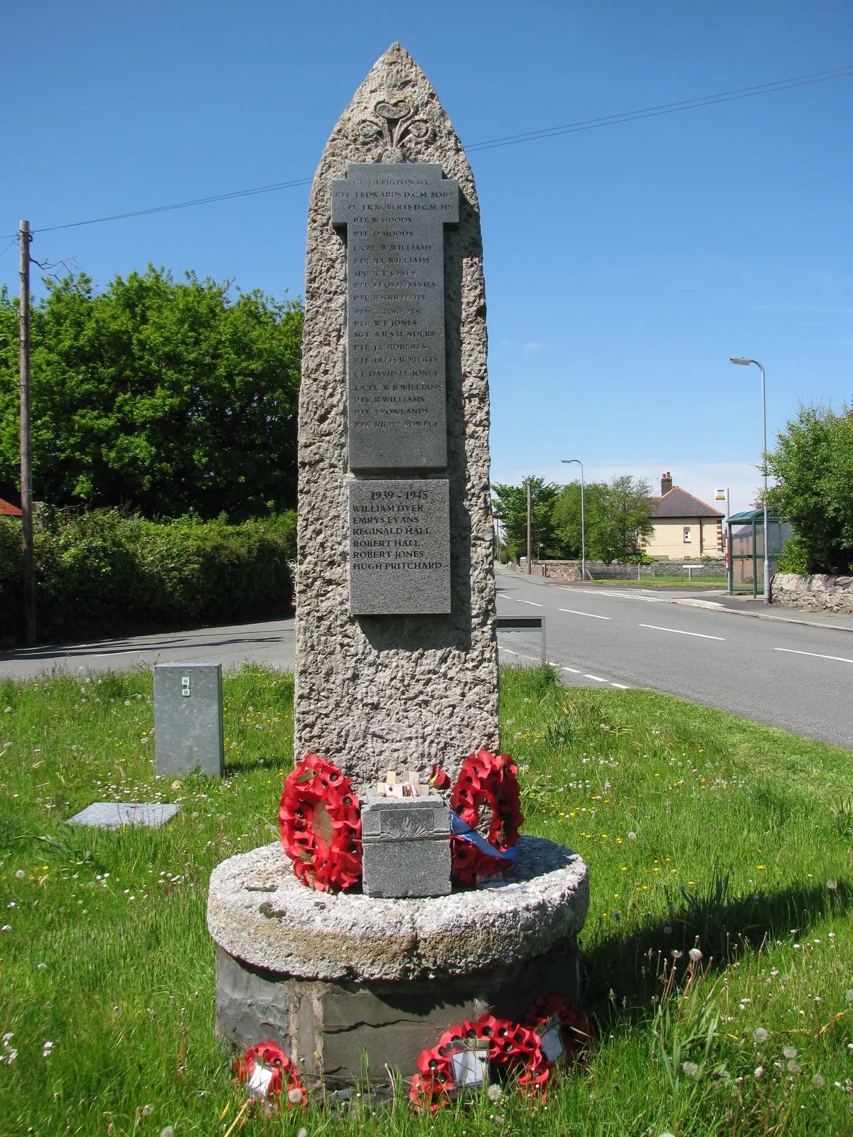 The war memorial at Dwygyfylchi, a tall granite obelisk with poppy wreaths laid at its base