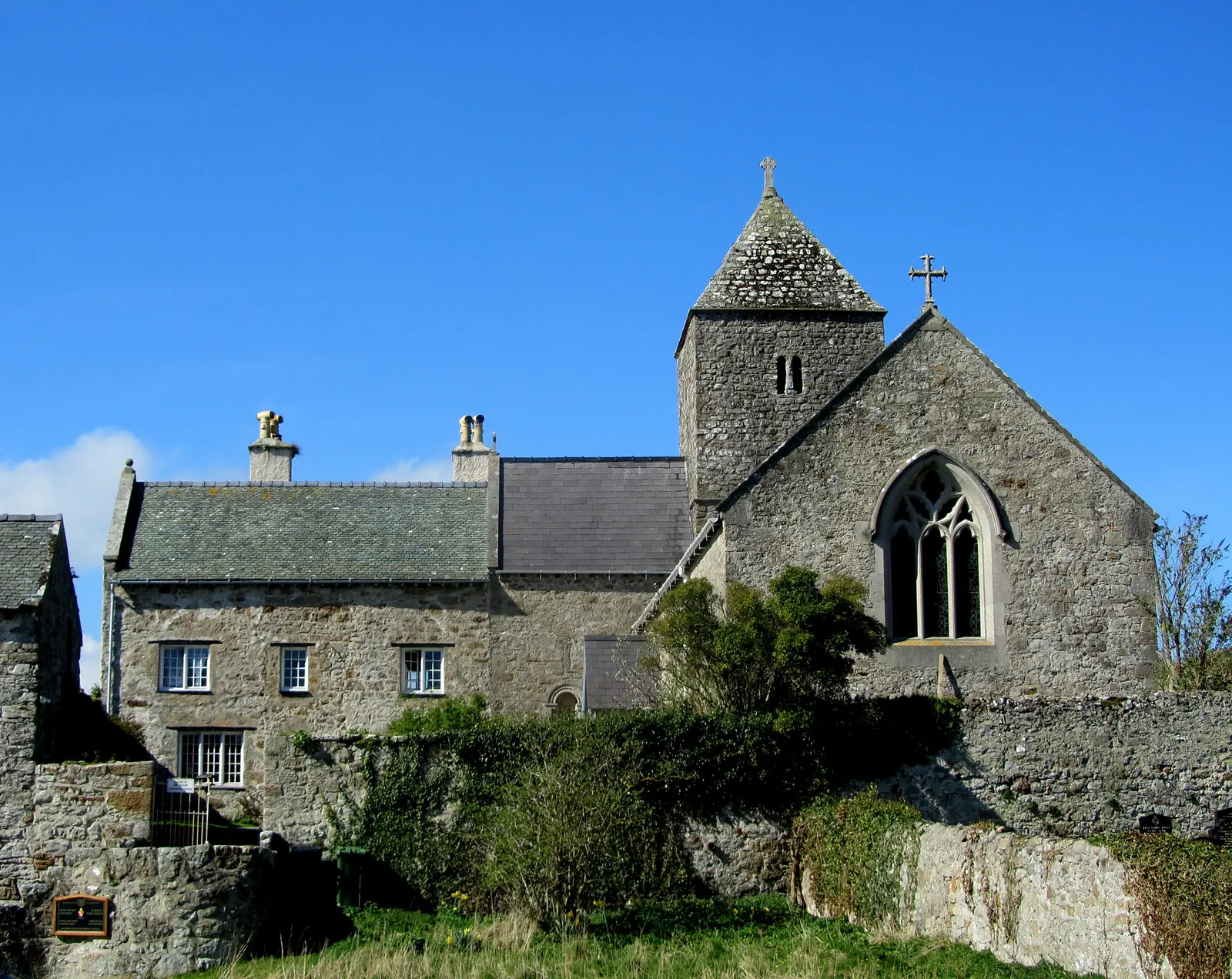 The stone exterior of St Seiriol's church at Penmon Priory, a mile inland from the Point.