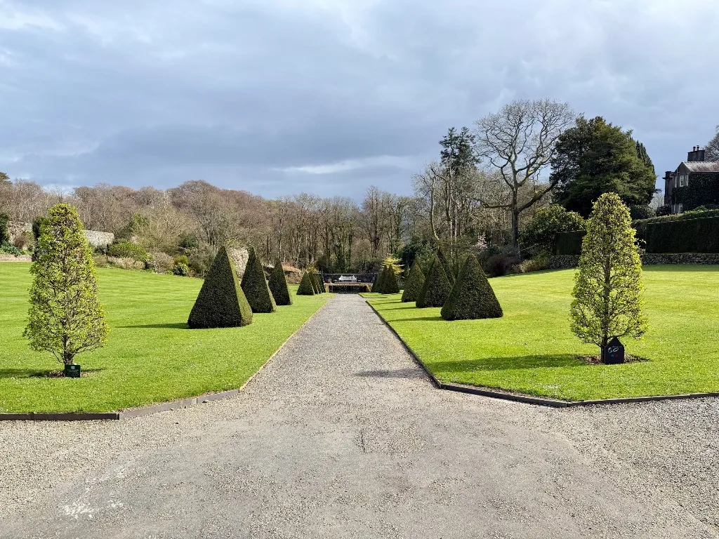 A planted path winding through the restored gardens at Plas Cadnant.
