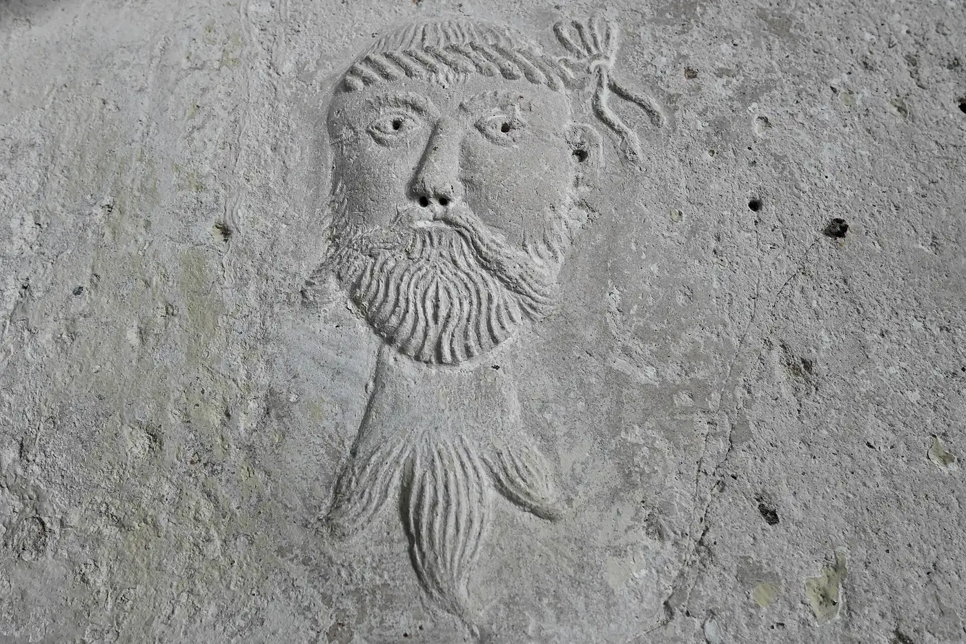 A close view of the parlour's original painted plasterwork at Plas Mawr, including a carved decorative face.