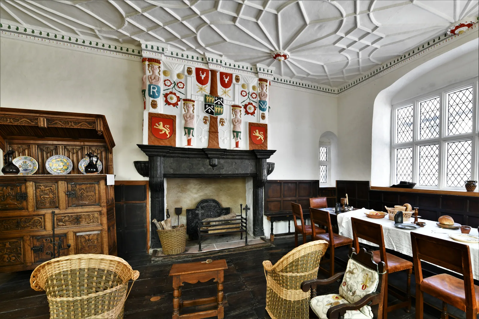 The entrance hall at Plas Mawr, repainted in its original colours, with a plasterwork overmantel.