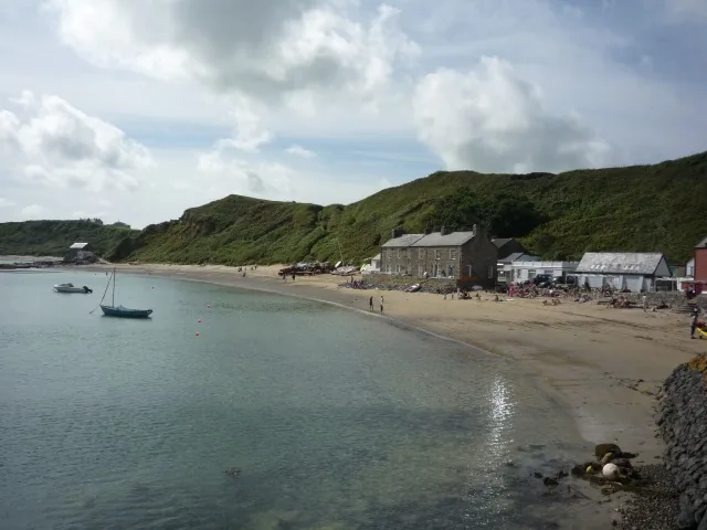 The whitewashed cottages of Porthdinllaen along the beach of its sheltered fishing headland, Llŷn Peninsula, Gwynedd.